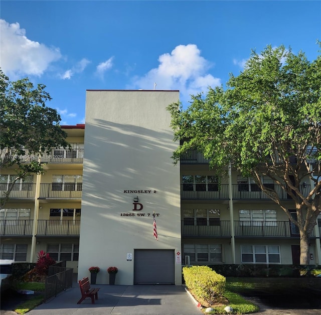 13255 SW 7th Ct Unit 401D, Pembroke Pines, FL 33027 - view of apartment building / complex featuring an attached garage and driveway