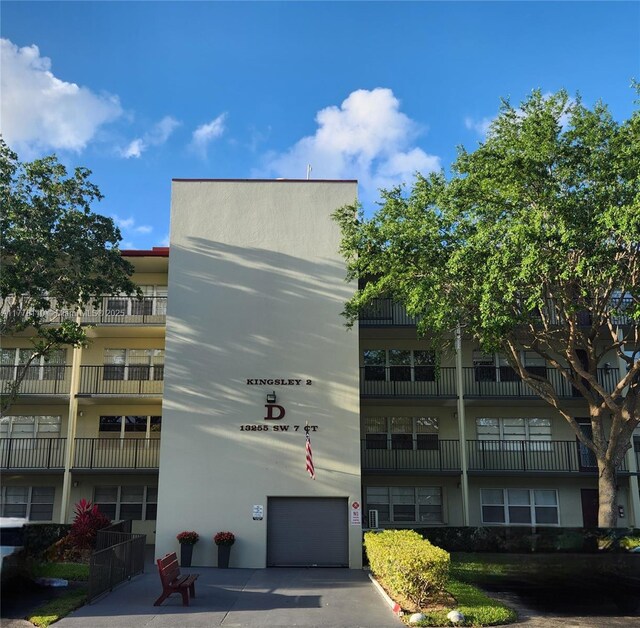 13255 SW 7th Ct Unit 401D, Pembroke Pines, FL 33027 - view of apartment building / complex featuring an attached garage and driveway