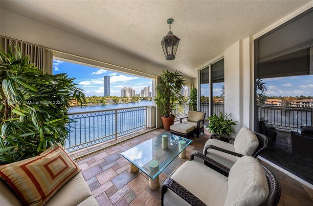balcony featuring an outdoor hangout area and a water view