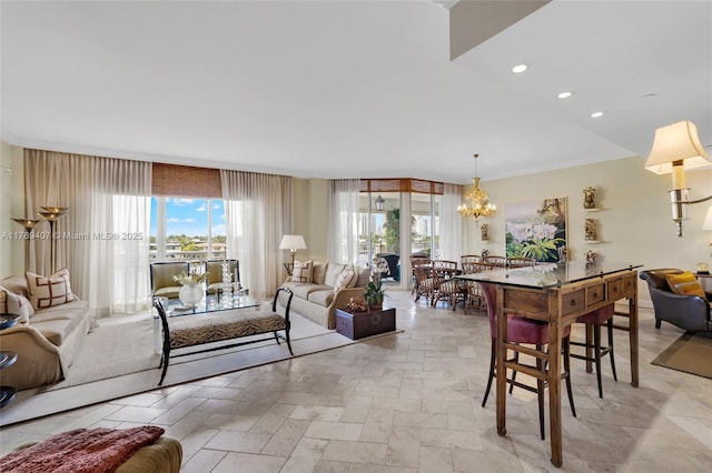 living room with recessed lighting, a notable chandelier, and stone tile flooring