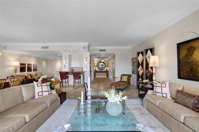 living room with crown molding and visible vents