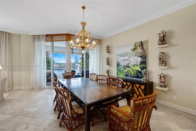 dining space featuring baseboards, ornamental molding, a notable chandelier, and stone tile floors