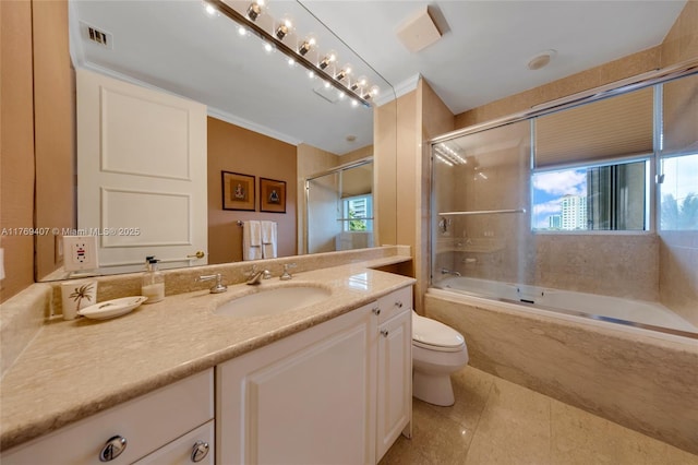 full bathroom featuring vanity, visible vents, toilet, bath / shower combo with glass door, and tile patterned floors