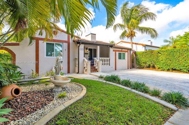 1500 SW 18th St, Miami, FL 33145 - mediterranean / spanish home with covered porch, stucco siding, a tiled roof, and a chimney