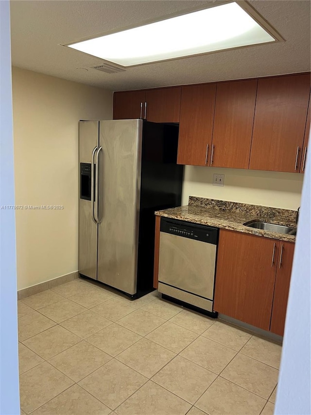 3300 NE 192nd St Unit 616, Aventura, FL 33180 - kitchen featuring a sink, baseboards, appliances with stainless steel finishes, and dark stone counters