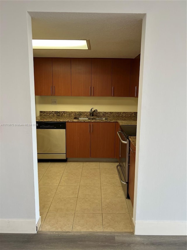 3300 NE 192nd St Unit 616, Aventura, FL 33180 - kitchen with appliances with stainless steel finishes, a sink, baseboards, and dark countertops