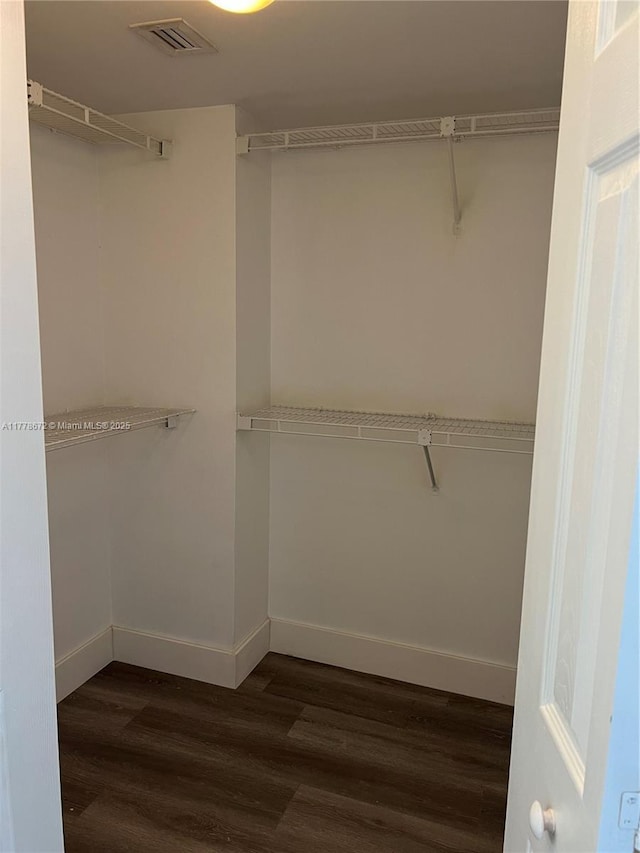 3300 NE 192nd St Unit 616, Aventura, FL 33180 - spacious closet with visible vents and dark wood-style floors