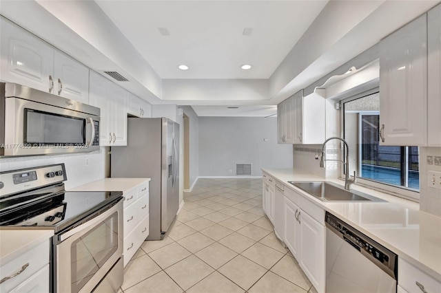 kitchen featuring a sink, light countertops, white cabinetry, and stainless steel appliances