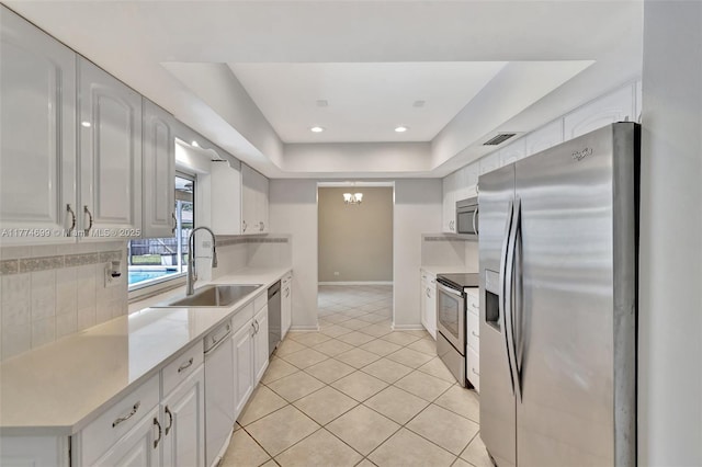 kitchen featuring visible vents, a sink, light countertops, stainless steel appliances, and backsplash