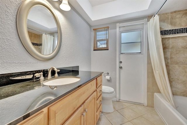 full bath featuring shower / bath combination with curtain, toilet, a textured wall, vanity, and tile patterned floors