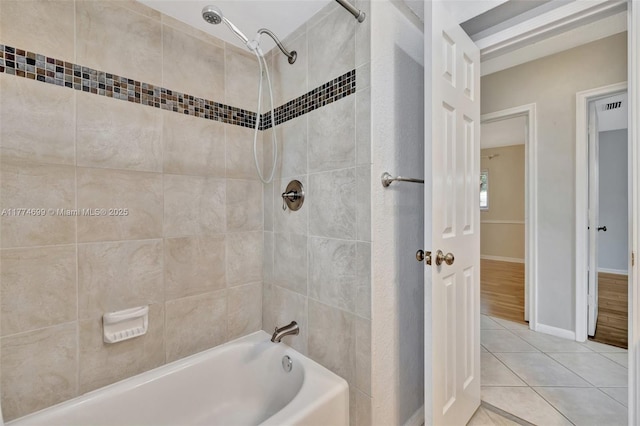 bathroom featuring visible vents, tile patterned floors, shower / washtub combination, and baseboards