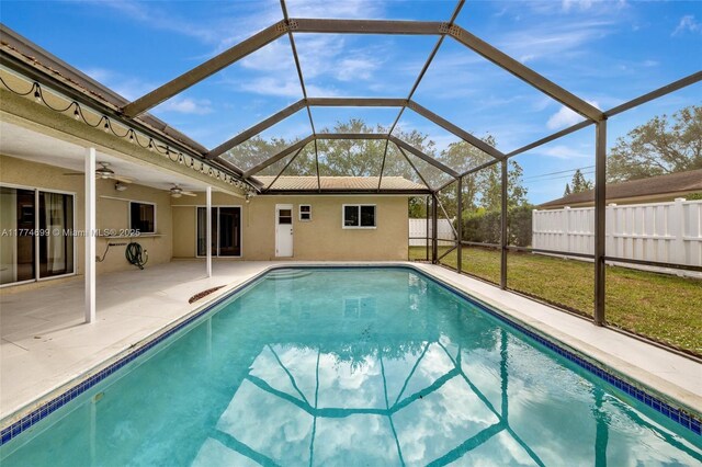 view of swimming pool with a ceiling fan, a patio, a fenced in pool, and fence