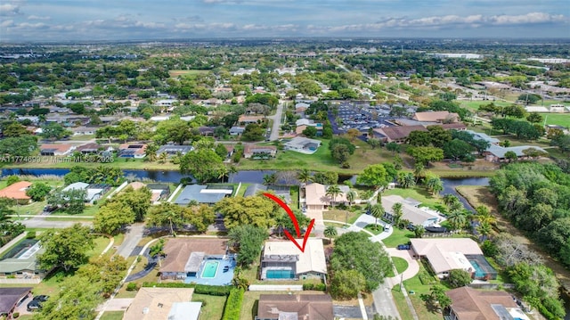 drone / aerial view with a residential view and a water view