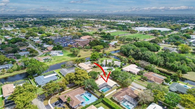 birds eye view of property with a water view and a residential view