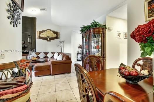 dining area with light tile patterned flooring and visible vents