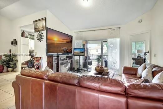 living room with tile patterned floors and lofted ceiling