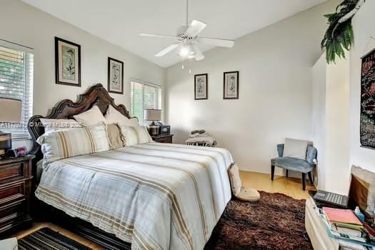 bedroom with vaulted ceiling and a ceiling fan