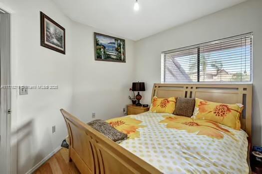 bedroom with wood finished floors