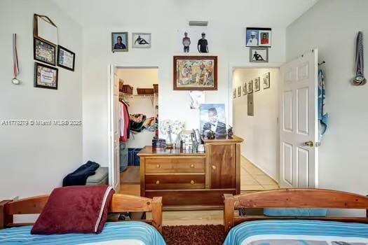 bedroom featuring a closet and a walk in closet