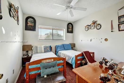 bedroom with a textured ceiling, ceiling fan, and baseboards