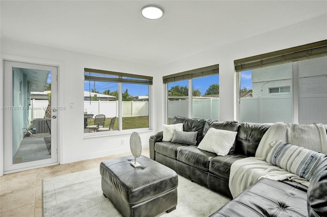 living room with light tile patterned flooring, plenty of natural light, and baseboards