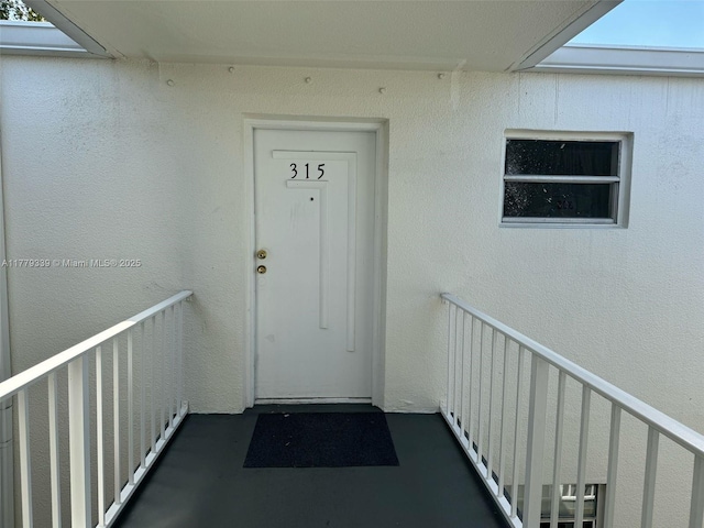 property entrance with stucco siding