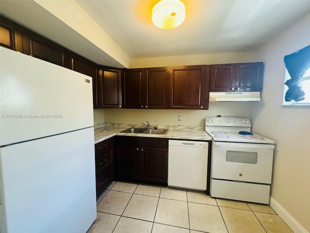 kitchen featuring light tile patterned floors, a sink, light countertops, white appliances, and under cabinet range hood
