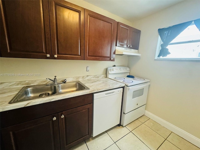 kitchen with under cabinet range hood, white appliances, light countertops, and a sink