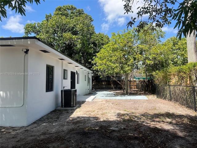 view of yard featuring central AC unit and a fenced backyard