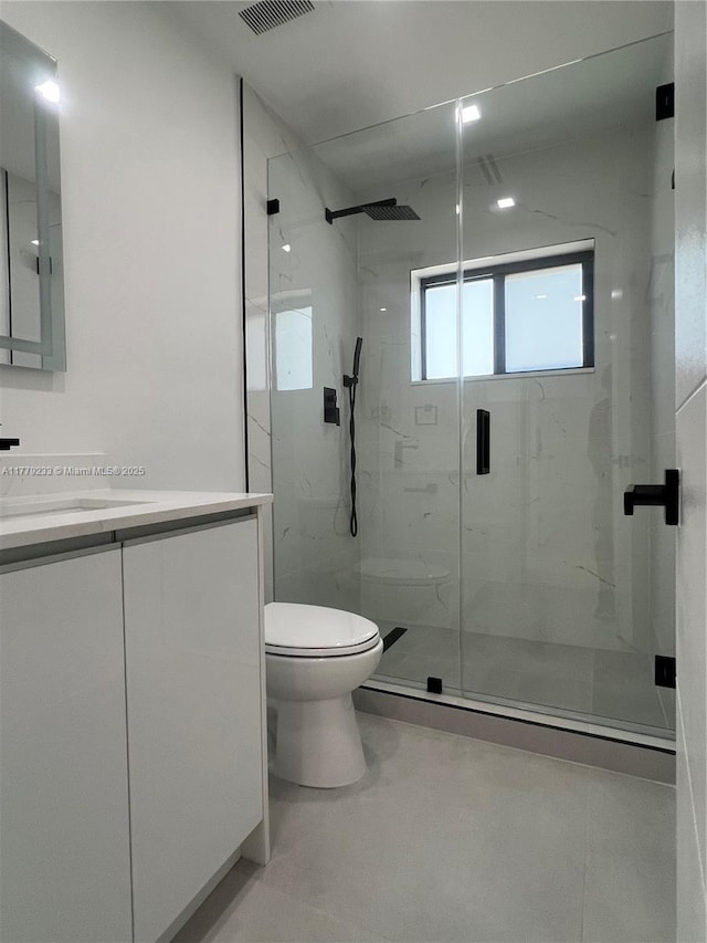 full bath featuring toilet, visible vents, a marble finish shower, and vanity