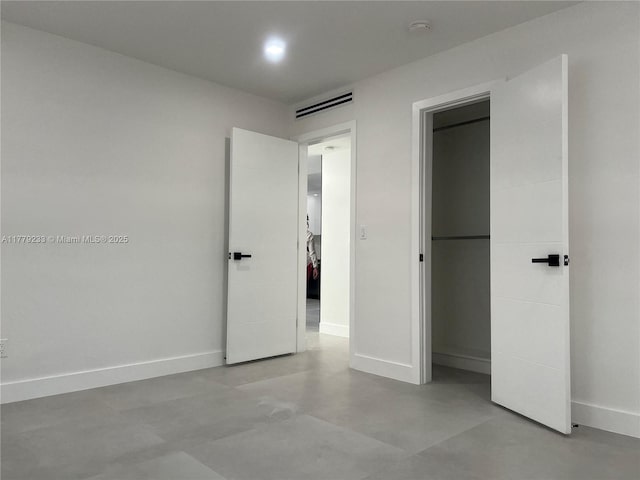 unfurnished bedroom with a closet, baseboards, and visible vents