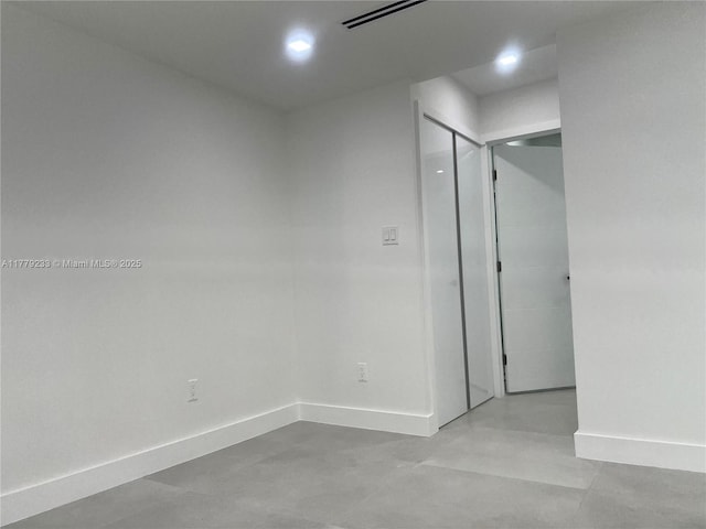 unfurnished room featuring visible vents and baseboards