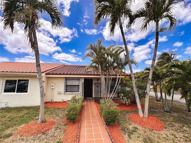 12459 SW 17th Ln, Miami, FL 33175 - view of front of home featuring stucco siding, a tiled roof, and a front yard