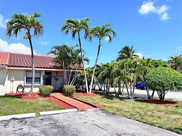 12459 SW 17th Ln, Miami, FL 33175 - view of front facade featuring a tiled roof, stucco siding, and a front lawn