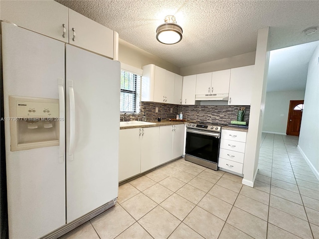 12459 SW 17th Ln, Miami, FL 33175 - kitchen featuring white fridge with ice dispenser, electric stove, under cabinet range hood, backsplash, and light tile patterned floors
