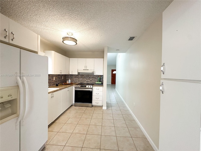 12459 SW 17th Ln, Miami, FL 33175 - kitchen featuring white refrigerator with ice dispenser, electric stove, under cabinet range hood, light tile patterned floors, and tasteful backsplash