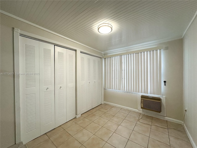 12459 SW 17th Ln, Miami, FL 33175 - unfurnished bedroom with a wall mounted AC, light tile patterned floors, baseboards, two closets, and crown molding