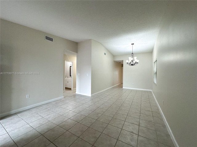 12459 SW 17th Ln, Miami, FL 33175 - unfurnished room with a chandelier, tile patterned flooring, a textured ceiling, and baseboards