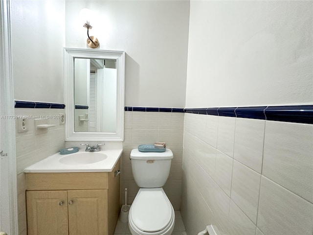 12459 SW 17th Ln, Miami, FL 33175 - half bathroom featuring tile walls, vanity, toilet, and wainscoting