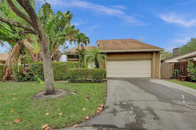 11724 SW 134th Ct, Miami, FL 33186 - view of front of property with a front yard, stucco siding, a garage, and aphalt driveway