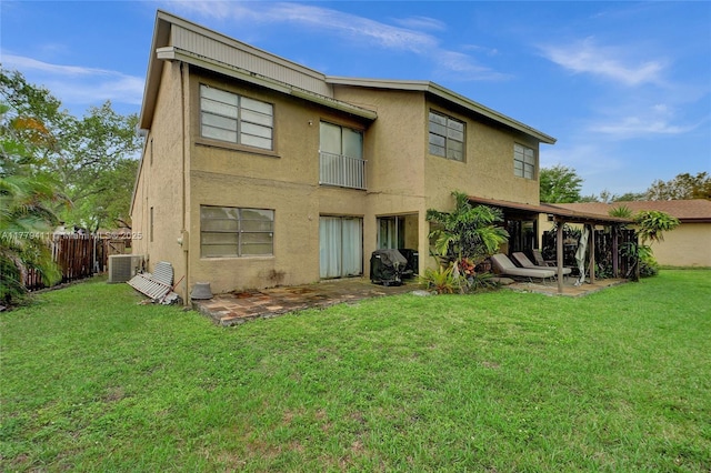11724 SW 134th Ct, Miami, FL 33186 - back of property with stucco siding, cooling unit, a patio area, fence, and a lawn