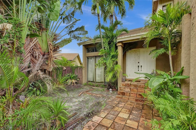 11724 SW 134th Ct, Miami, FL 33186 - view of exterior entry with stucco siding and fence