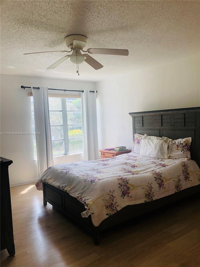 3776 Inverrary Blvd Unit 205R, Lauderhill, FL 33319 - bedroom featuring wood finished floors, a textured ceiling, and a ceiling fan