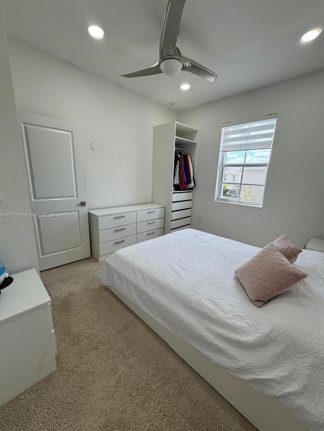 carpeted bedroom with a closet, ceiling fan, and recessed lighting