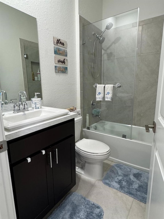bathroom with bathtub / shower combination, vanity, tile patterned flooring, toilet, and a textured wall