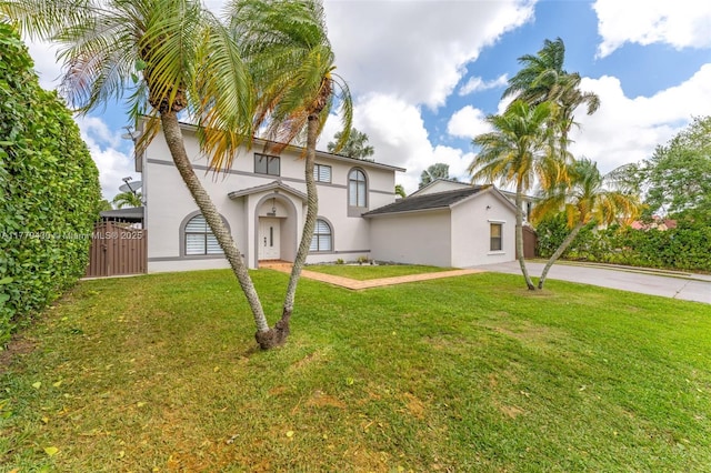 14481 SW 150th St, Miami, FL 33186 - view of front of home with driveway, stucco siding, fence, and a front lawn