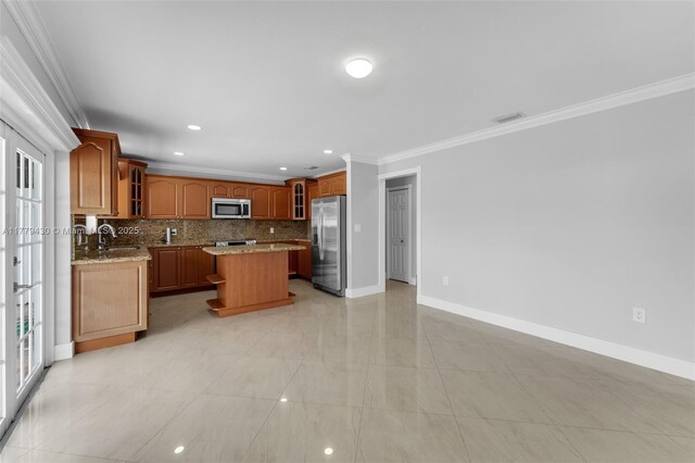 14481 SW 150th St, Miami, FL 33186 - kitchen featuring glass insert cabinets, tasteful backsplash, a kitchen island, a sink, and stainless steel appliances