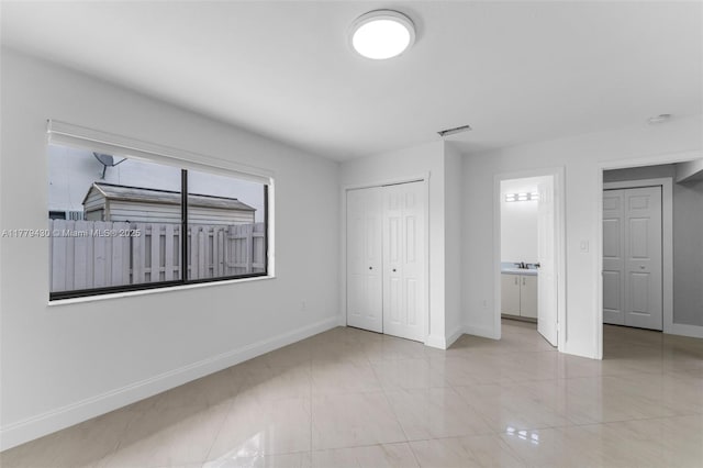 14481 SW 150th St, Miami, FL 33186 - unfurnished bedroom featuring visible vents, baseboards, a closet, a sink, and ensuite bath