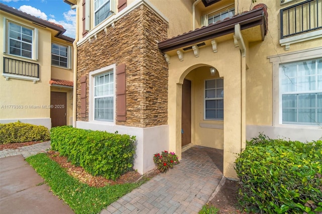 1720 NE 33rd Ave Unit 104-5, Homestead, FL 33033 - view of exterior entry with stone siding and stucco siding