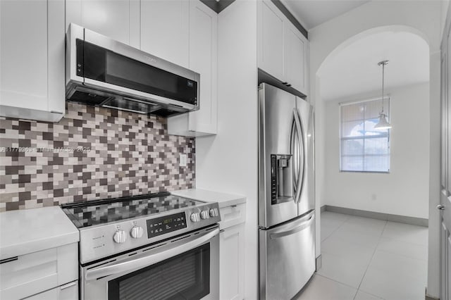 1720 NE 33rd Ave Unit 104-5, Homestead, FL 33033 - kitchen featuring appliances with stainless steel finishes, light countertops, white cabinets, and arched walkways